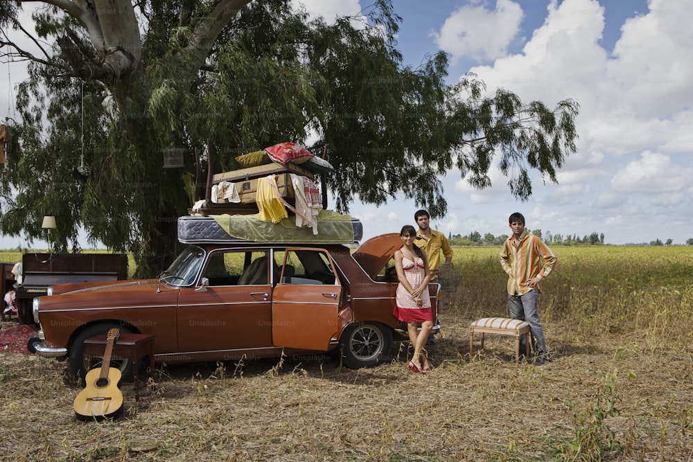 a man and a woman standing next to a car