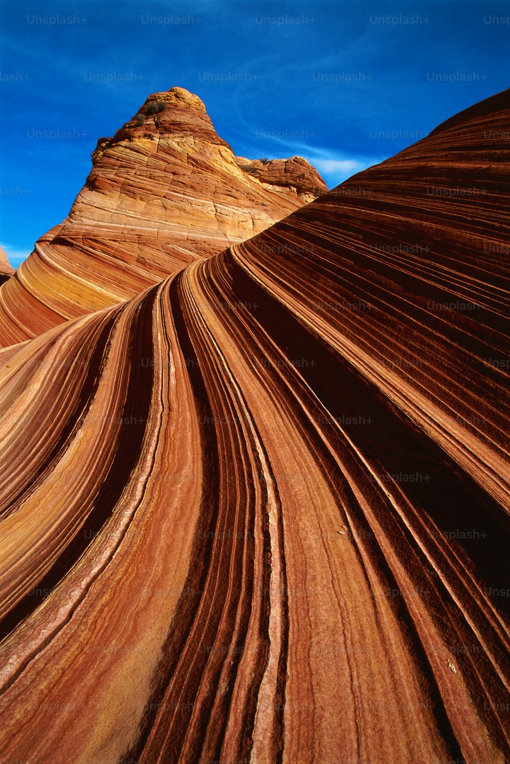 a large rock formation with a blue sky in the background