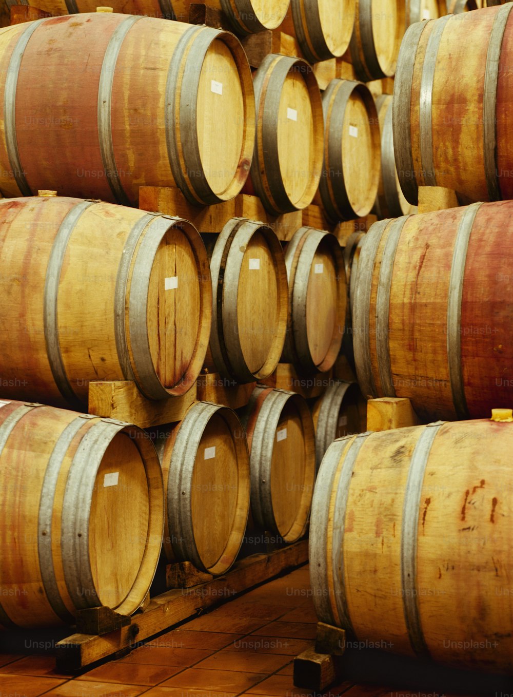 a bunch of wine barrels stacked on top of each other