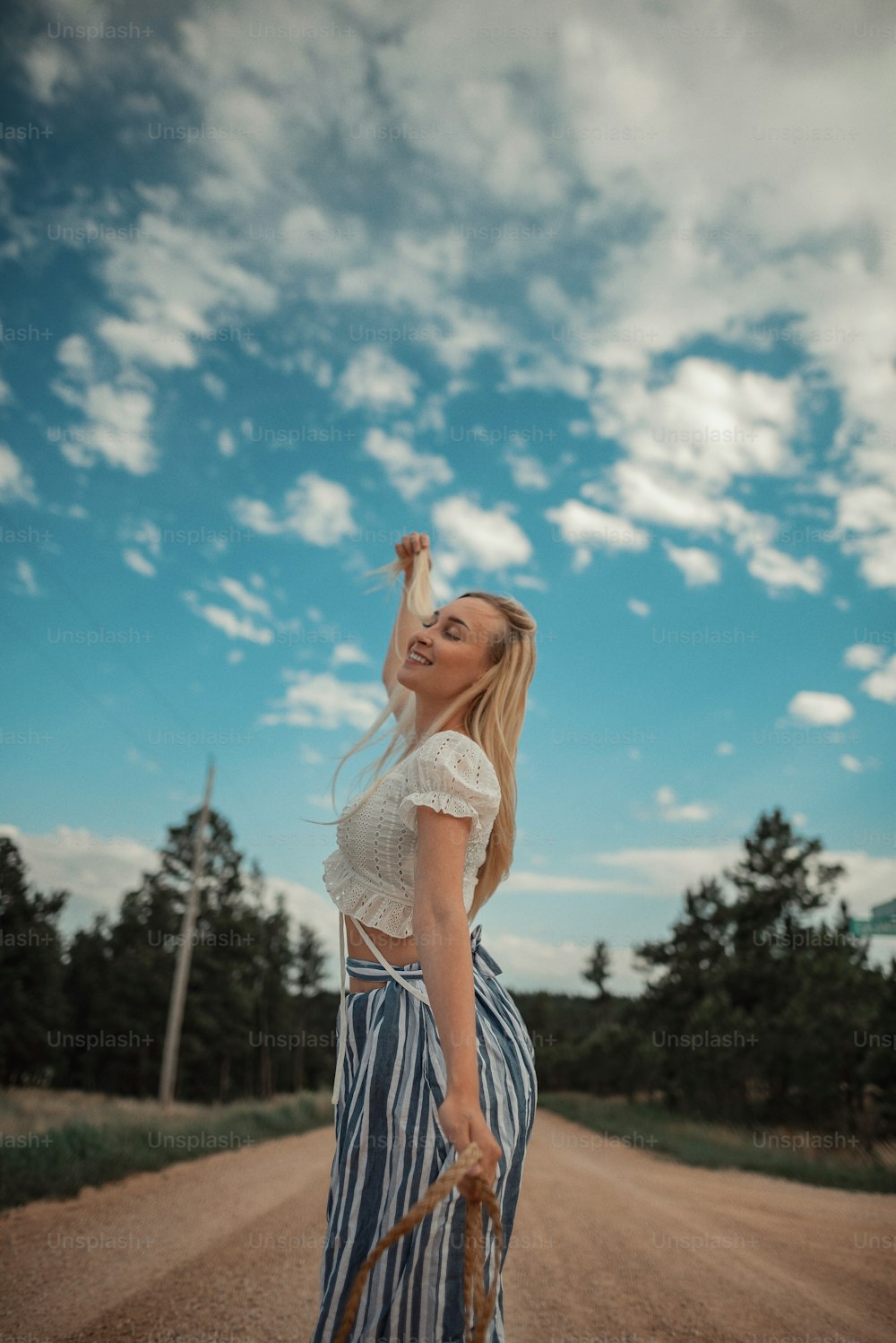 a woman in a striped skirt holding an umbrella