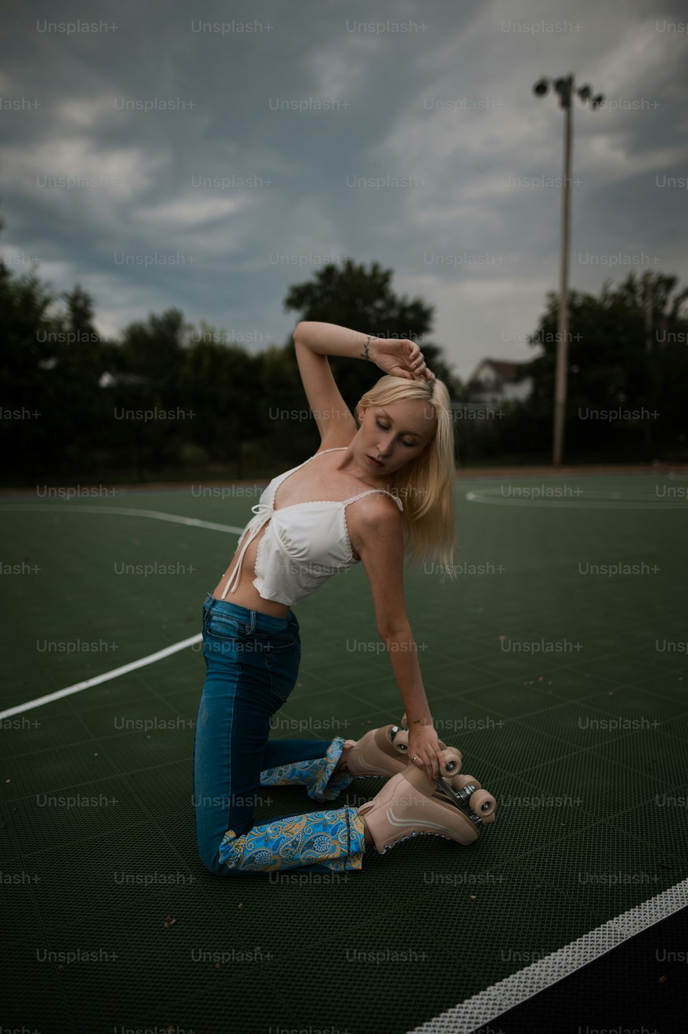 a woman is sitting on a tennis court