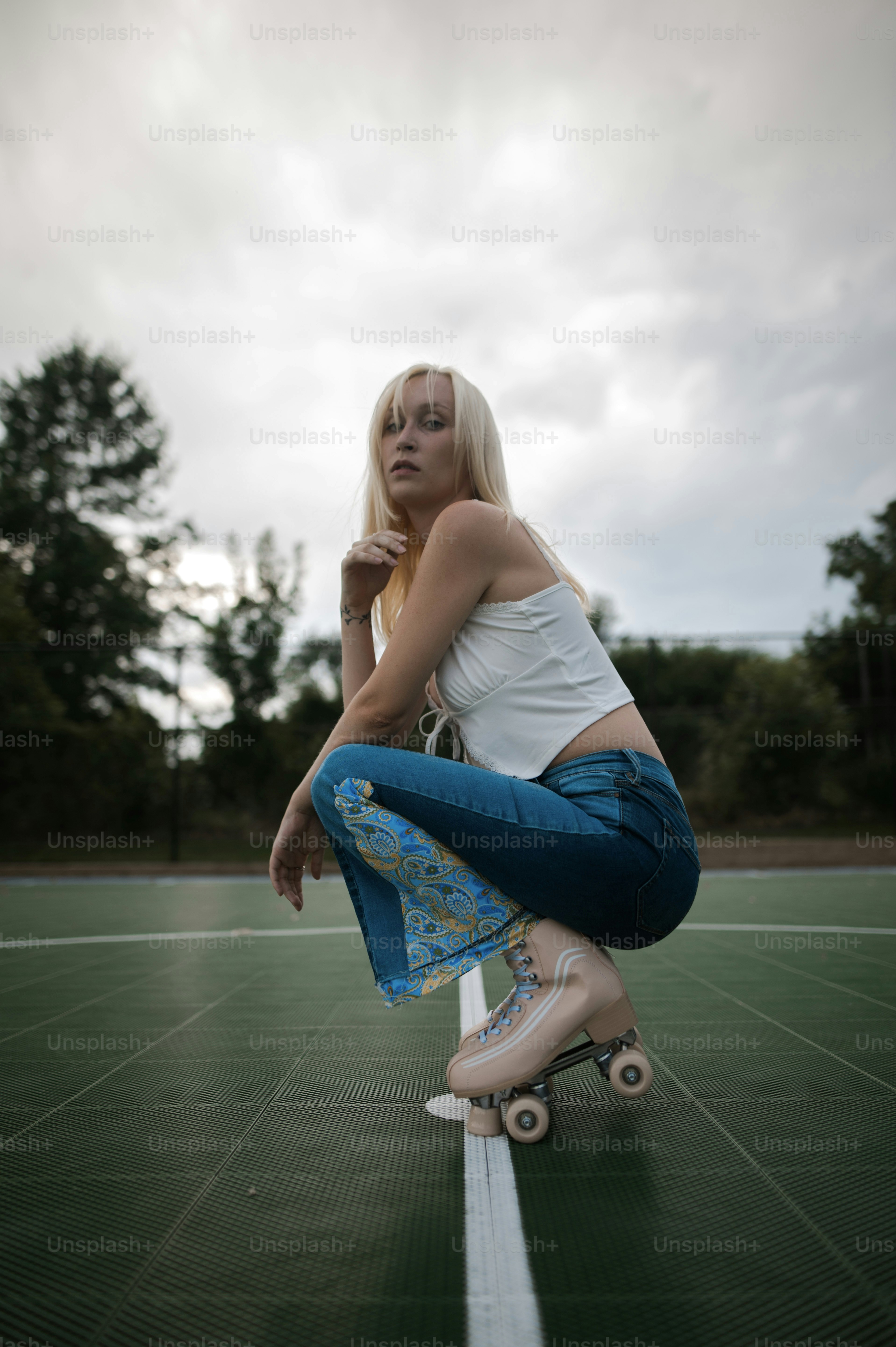 a woman kneeling down on a tennis court
