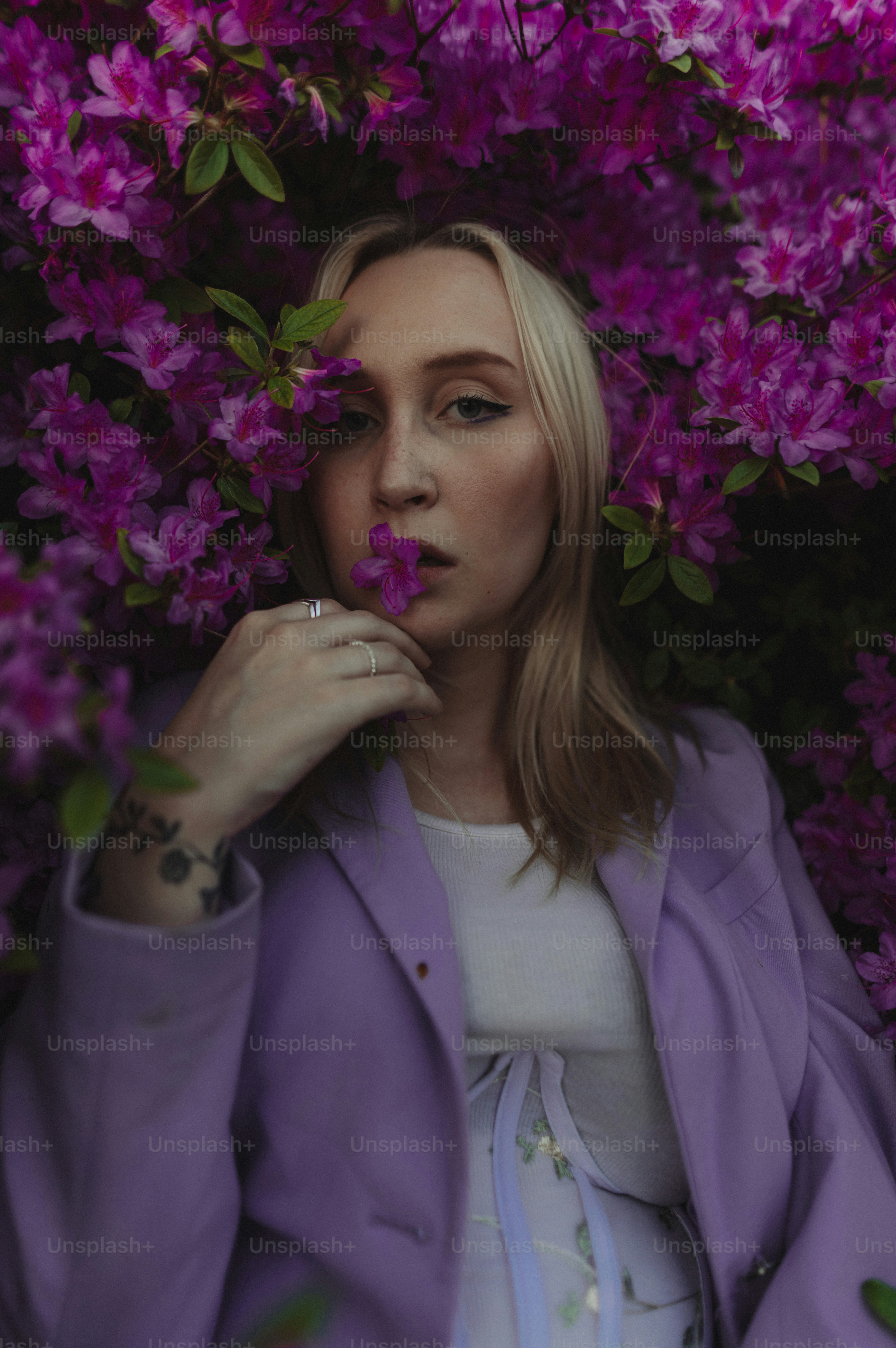 a woman with a flower in her mouth