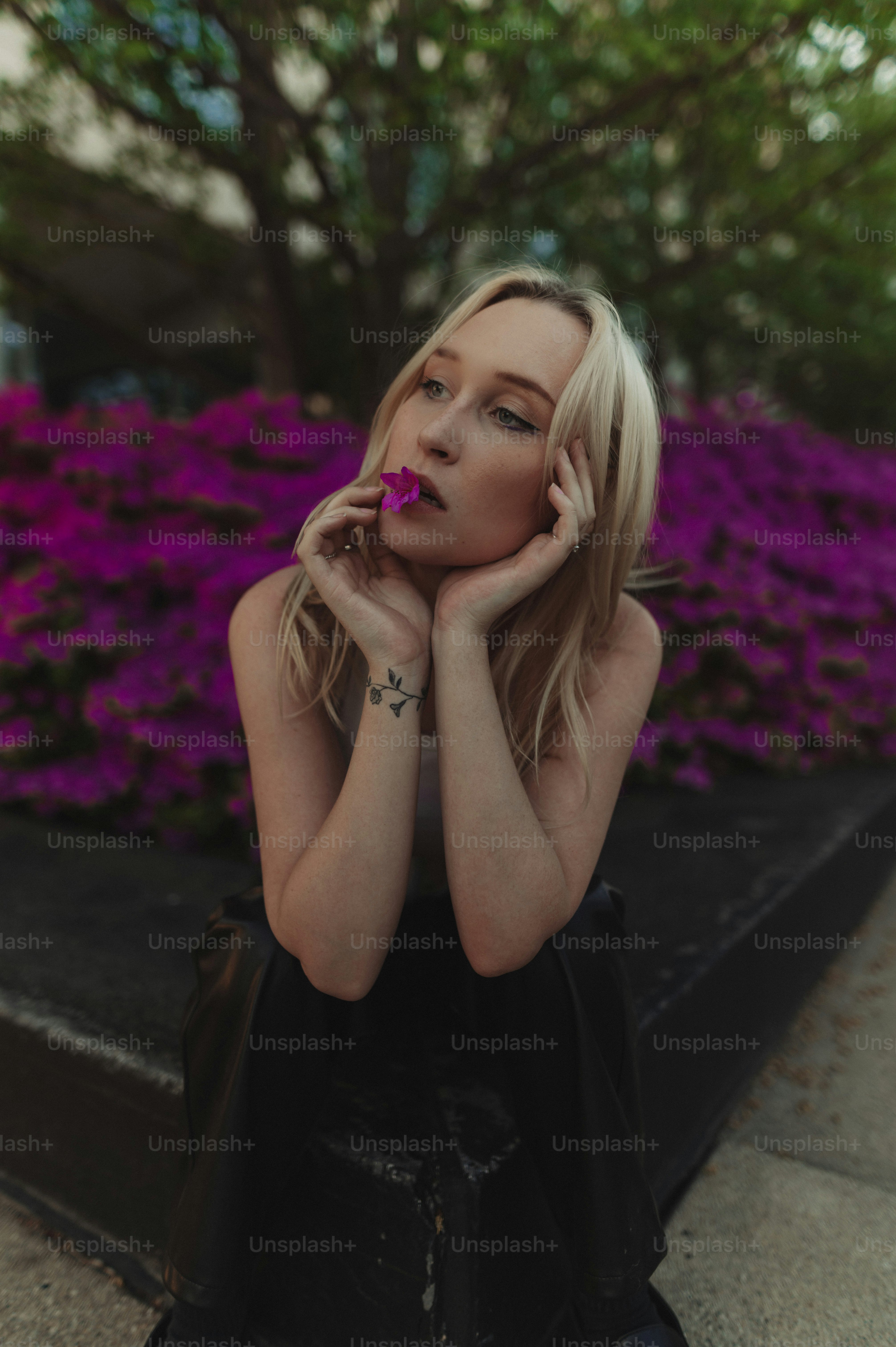 a woman sitting on a bench with her hand on her face