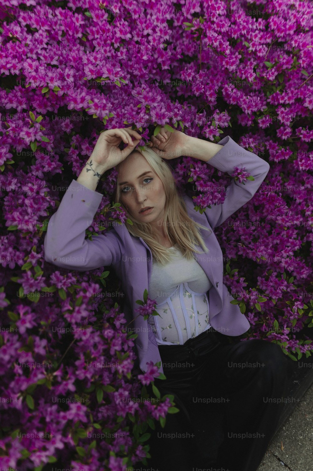 a woman sitting in a field of purple flowers