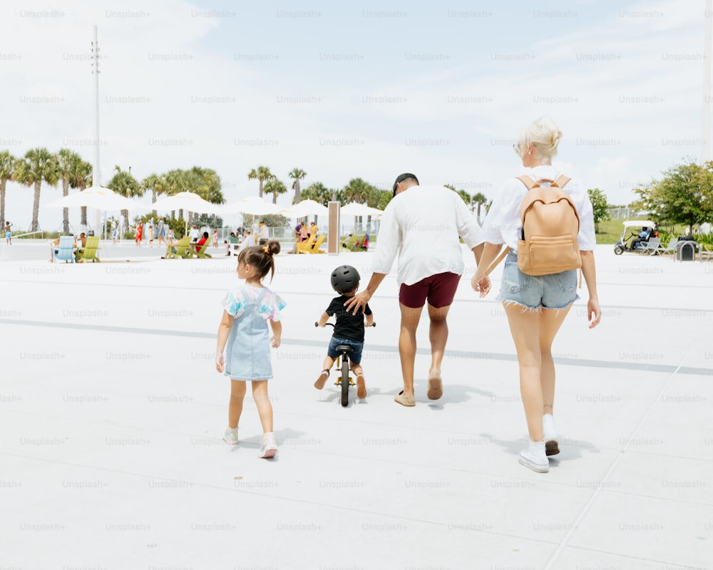 a group of people walking down a street holding hands