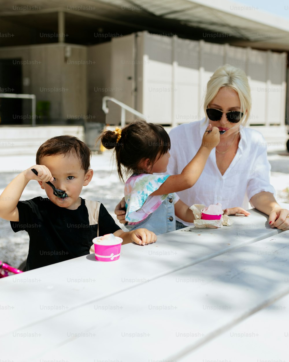 a woman and two children sitting at a table