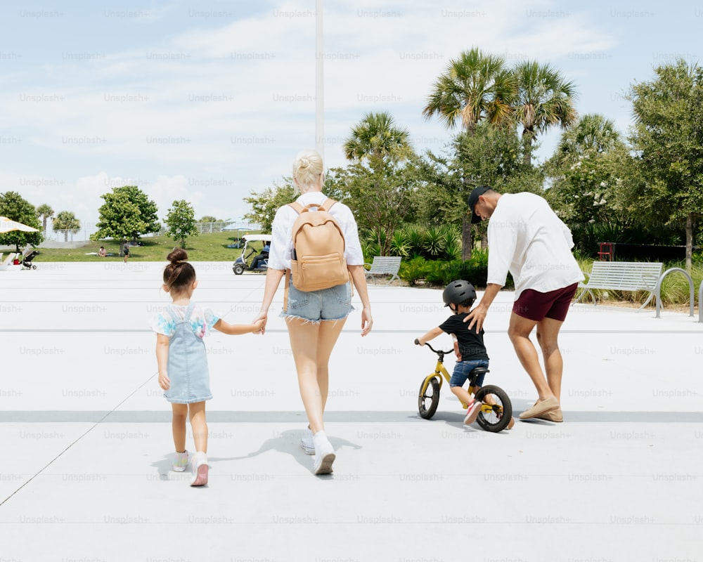 a man and a woman walking with a small child