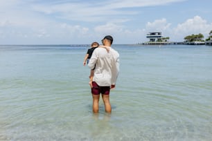 a man and a child are standing in the water