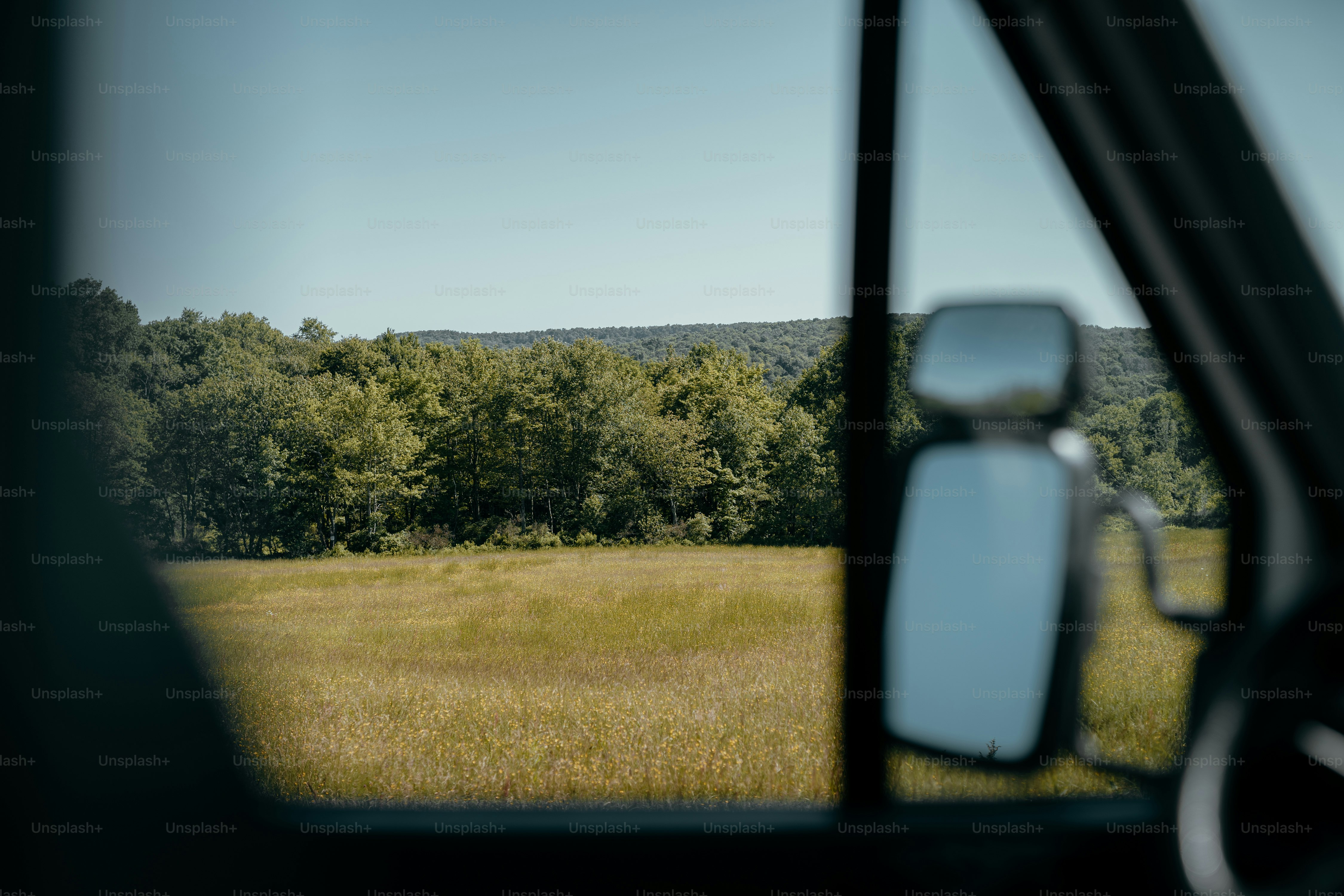 a view of a field through a car window