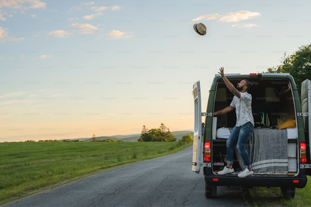 a man is throwing a frisbee into the back of a van