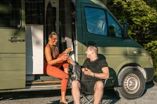 a man sitting in a chair next to a woman