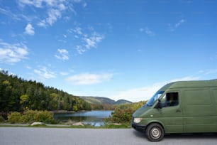a green van parked on the side of a road