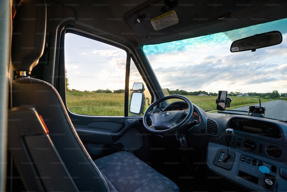 the inside of a truck with a view of a field