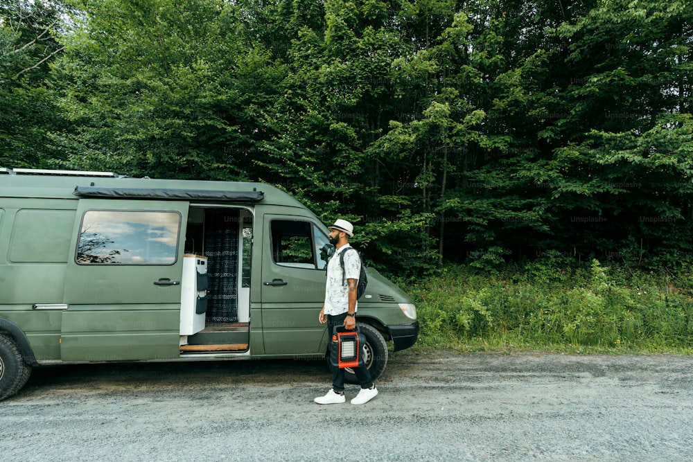 a man standing in front of a green van