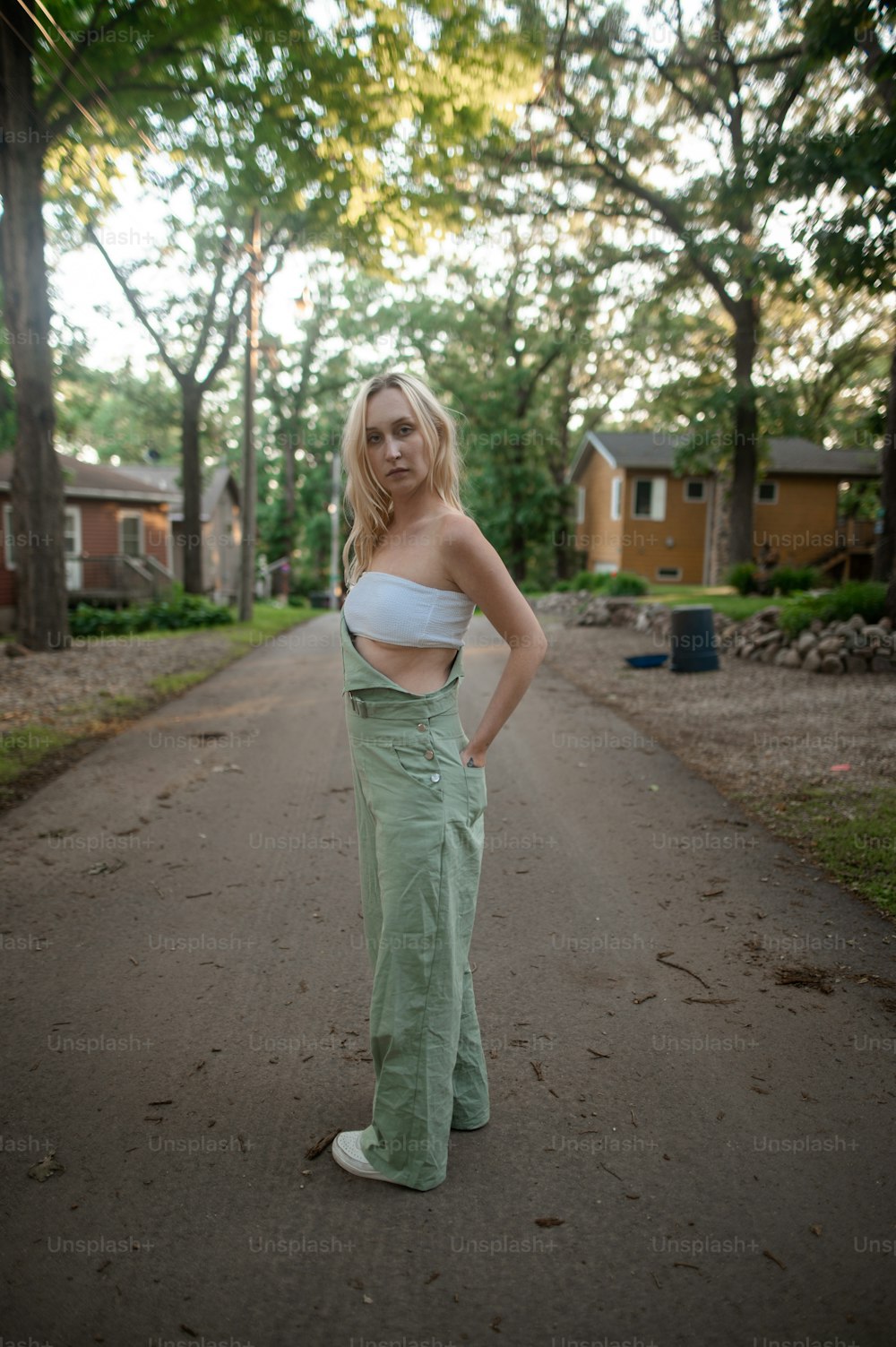 a woman standing in the middle of a road