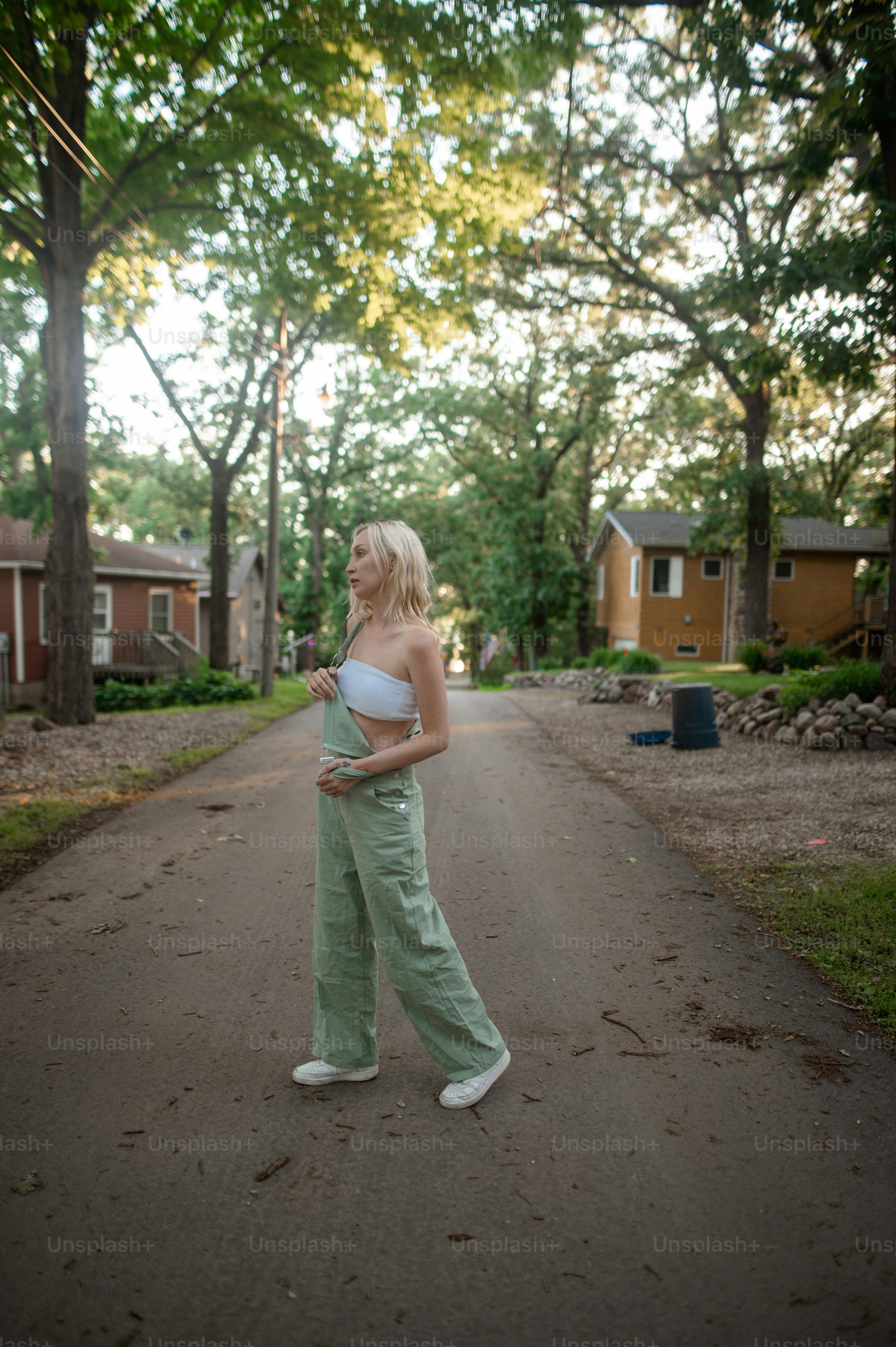 a woman standing in the middle of a road