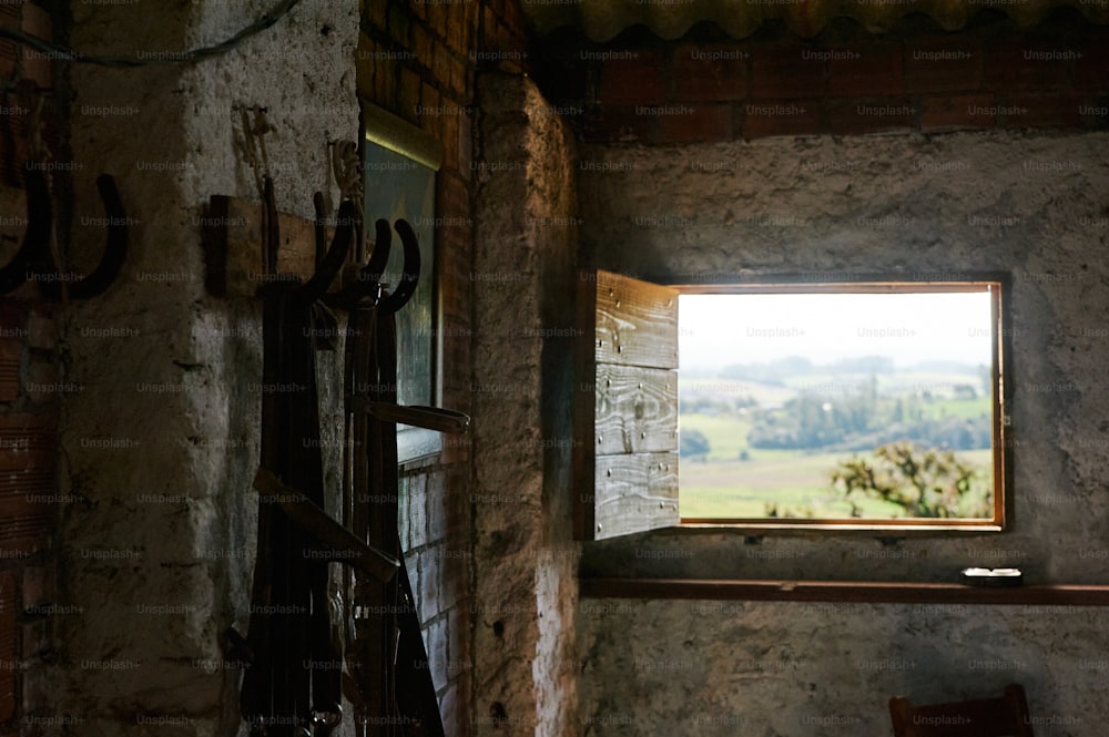 a window in a stone building with a view of the countryside