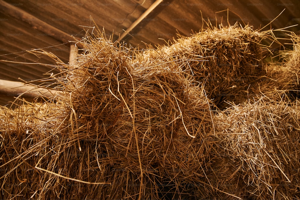 a pile of hay sitting on top of a wooden floor