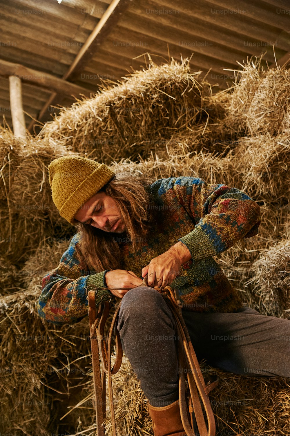 a man sitting on a pile of hay