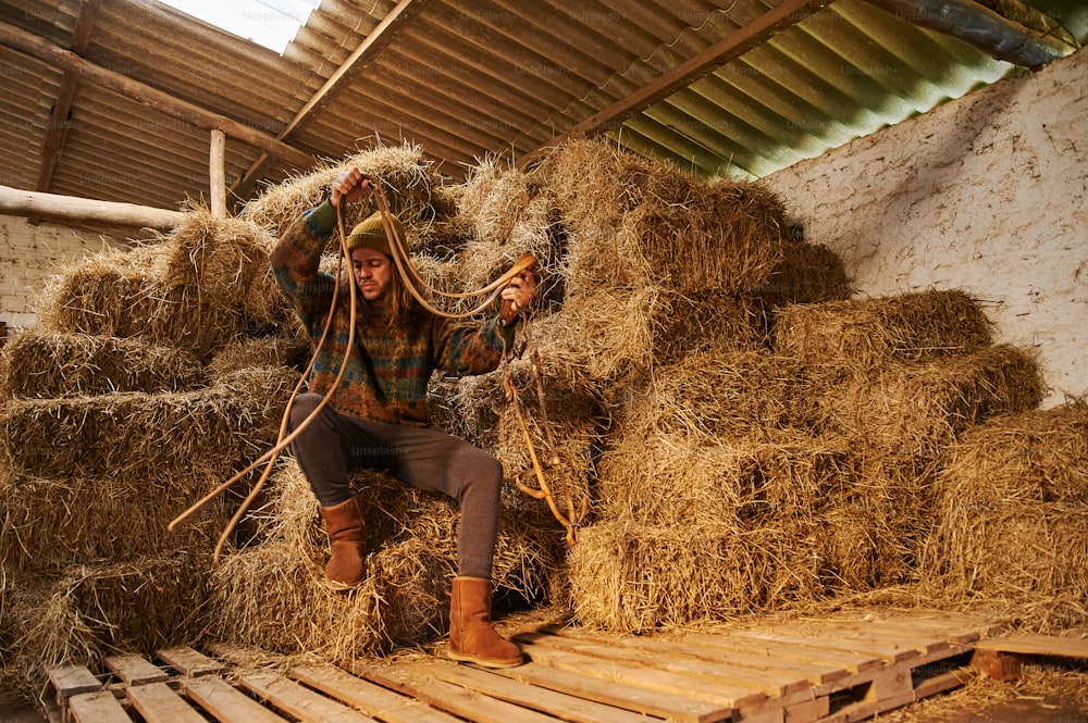 a person sitting on a pile of hay