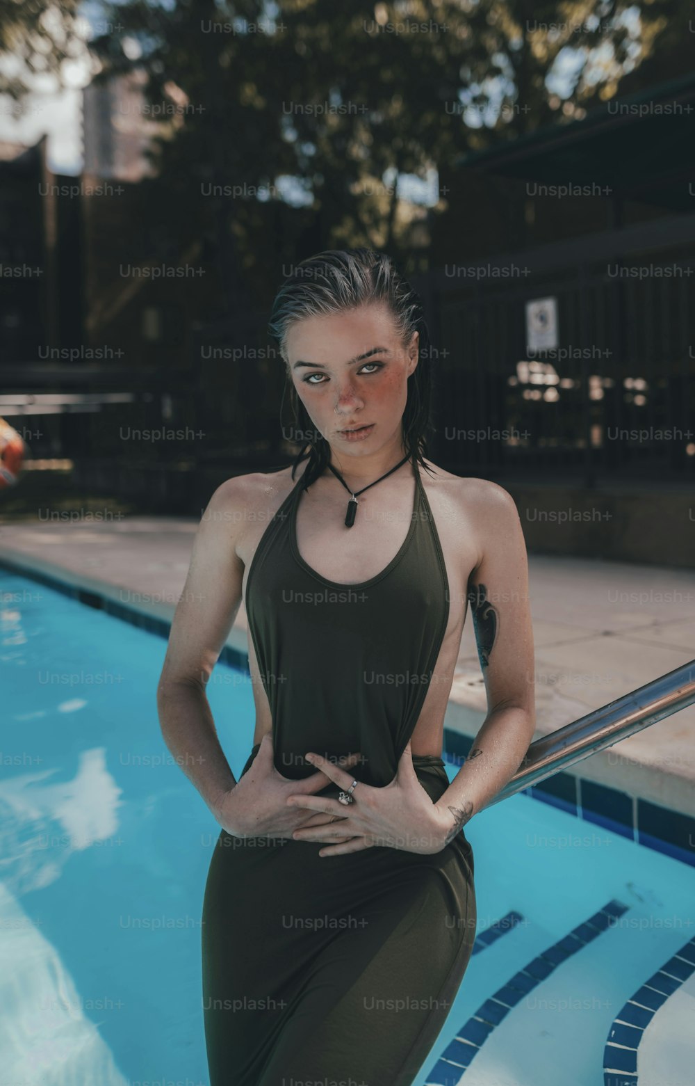 a woman standing in front of a swimming pool