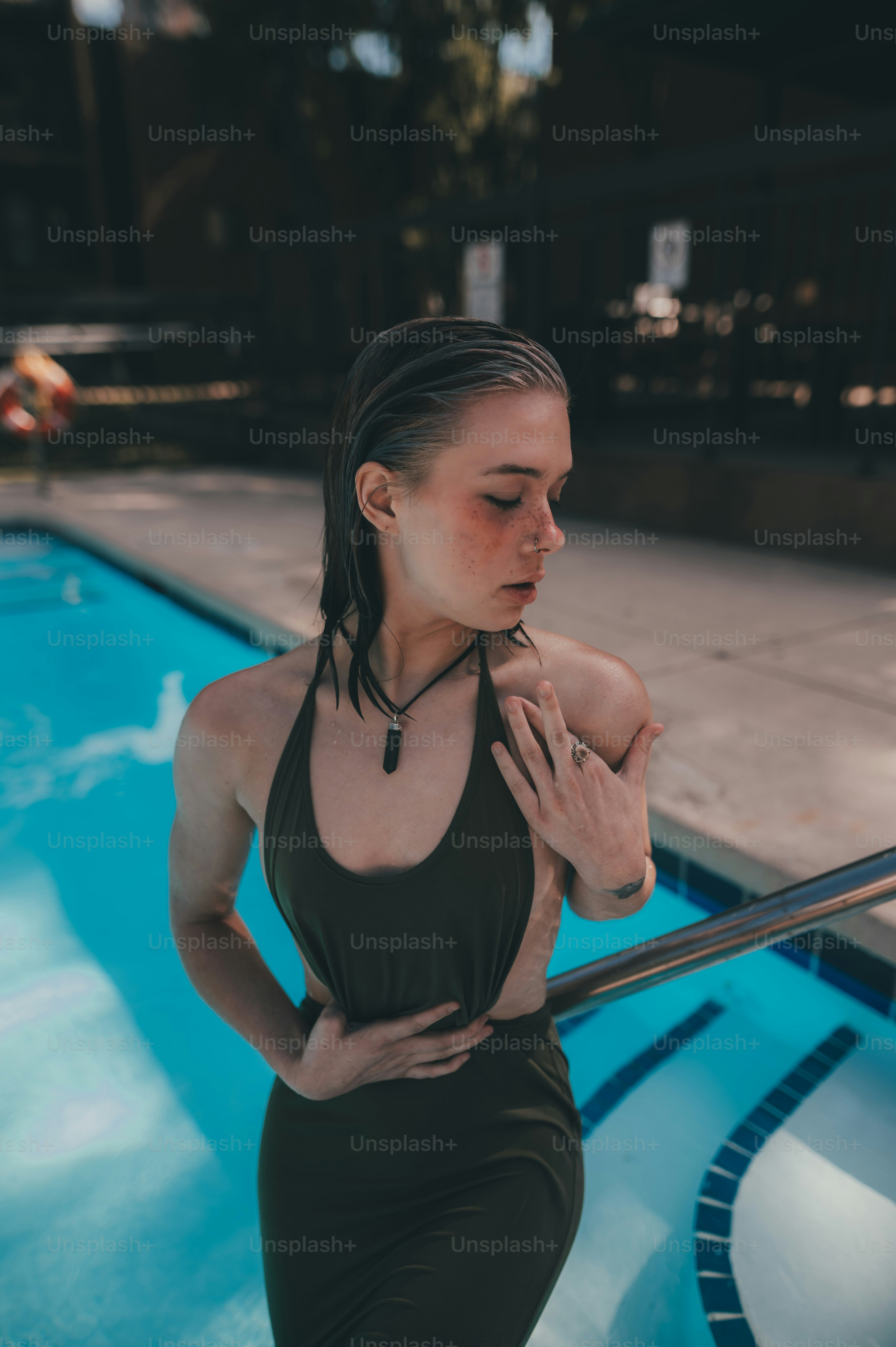 a woman standing in front of a swimming pool