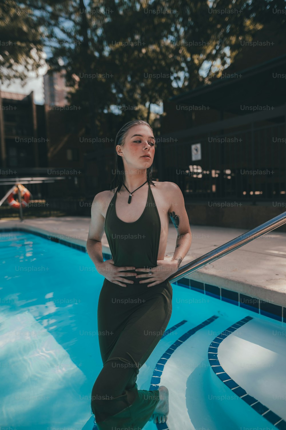 a woman standing in front of a swimming pool