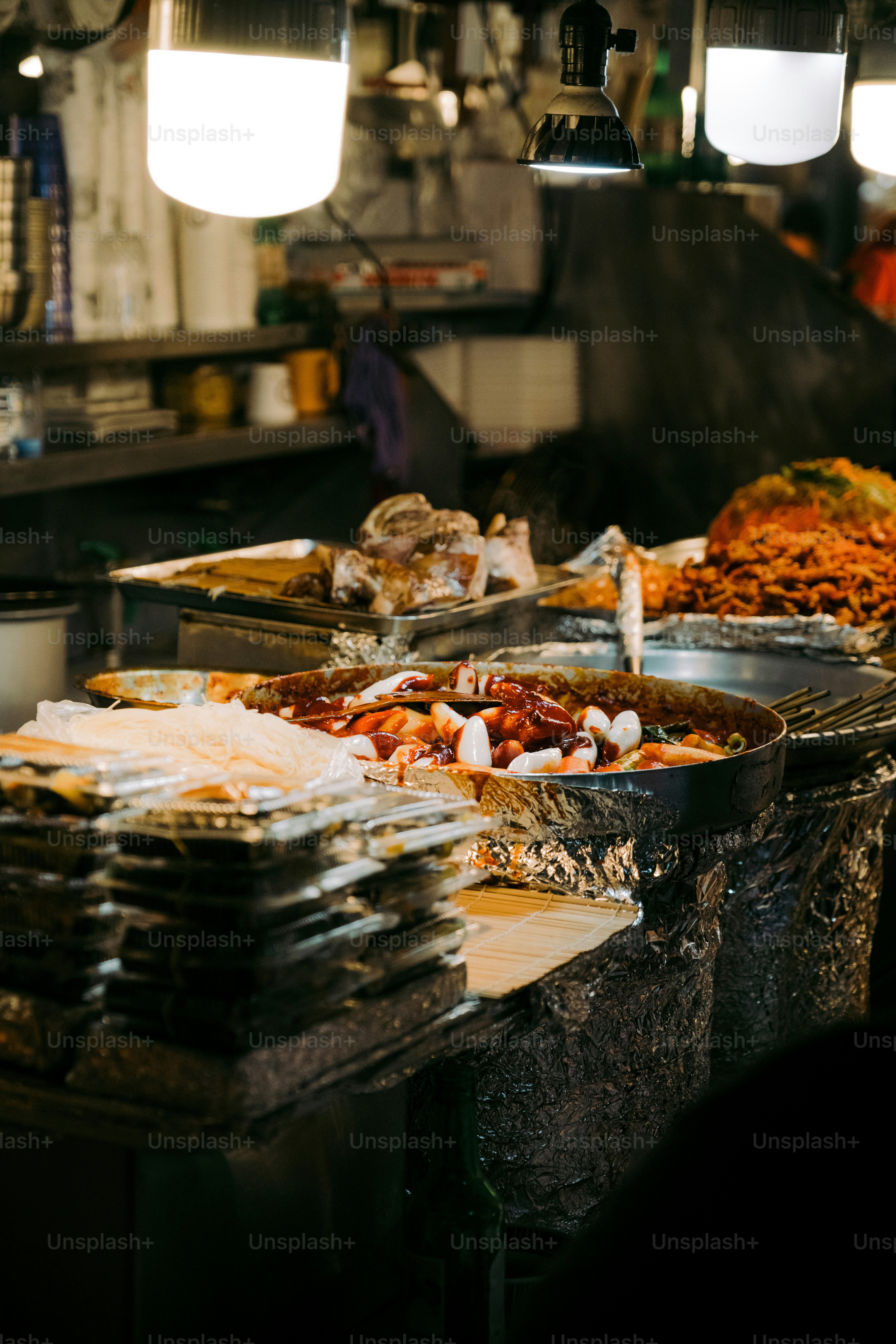 A bunch of trays of food that are on a table photo – Tokyo night Image