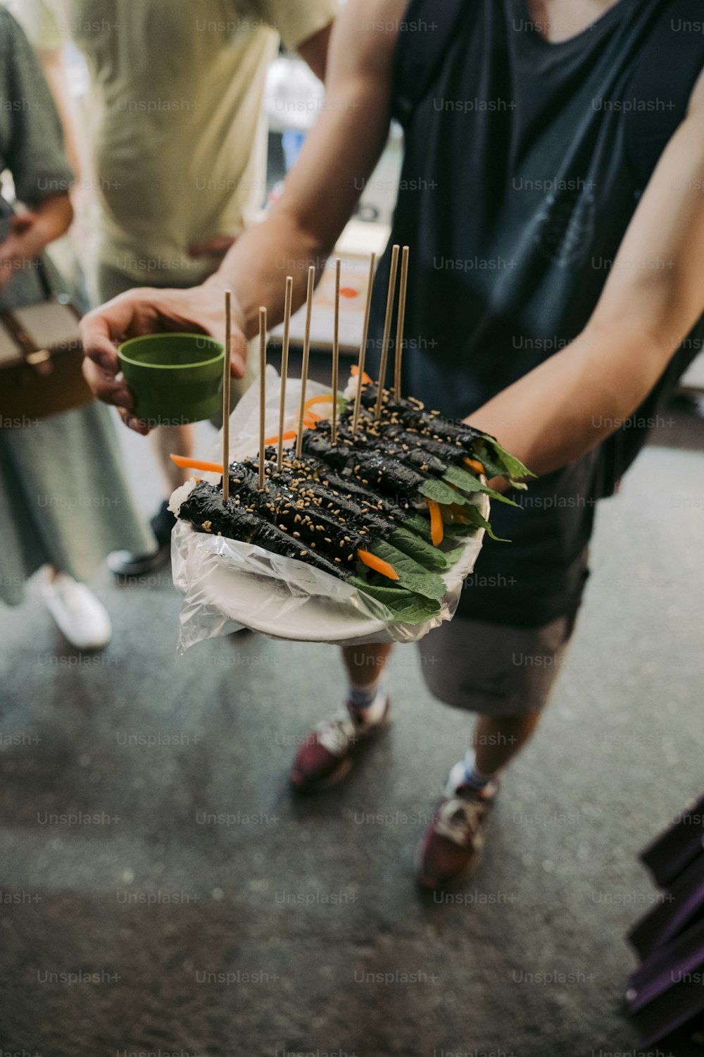 a group of people standing around a cake