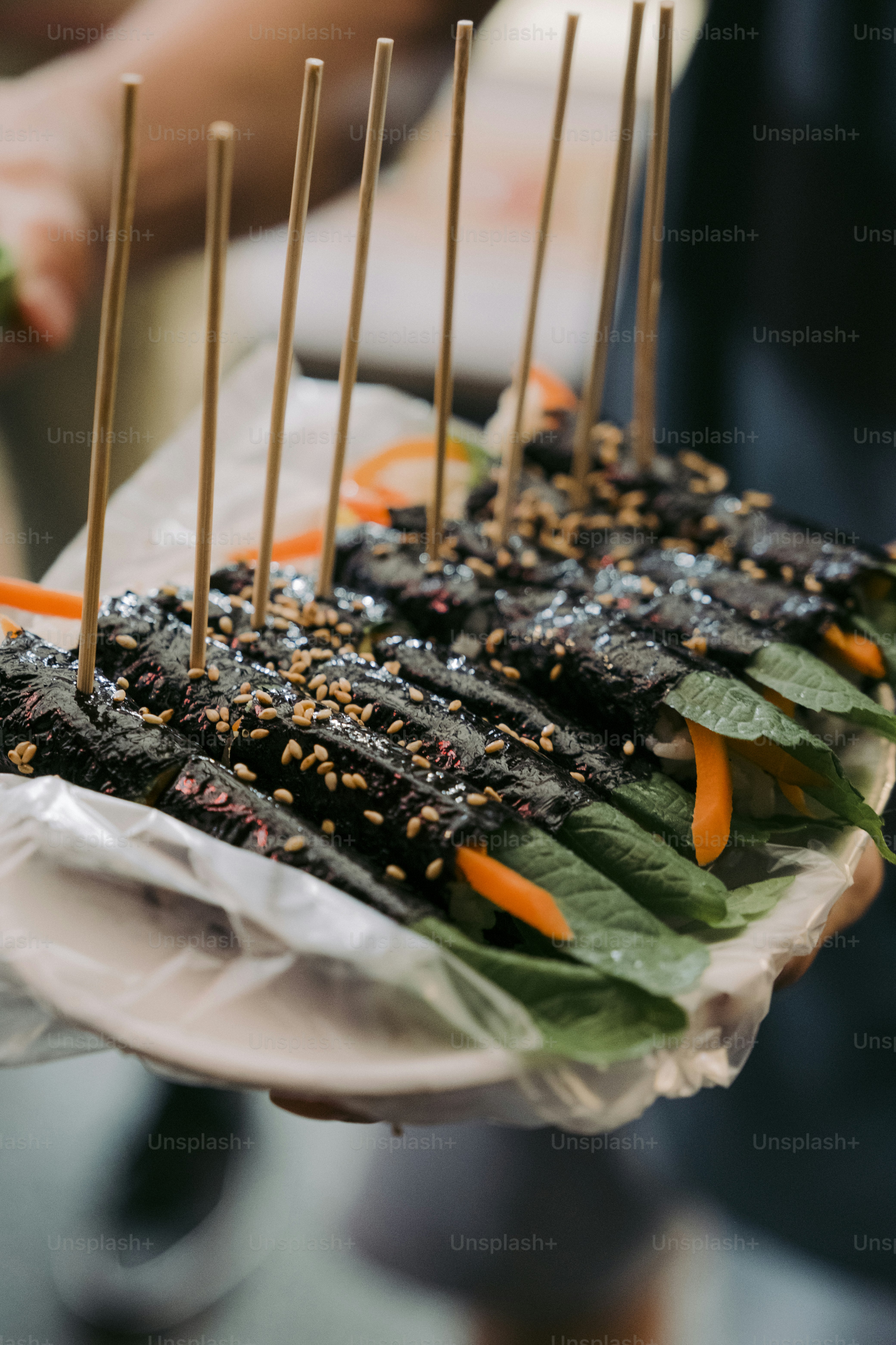 a tray of food with sticks sticking out of it