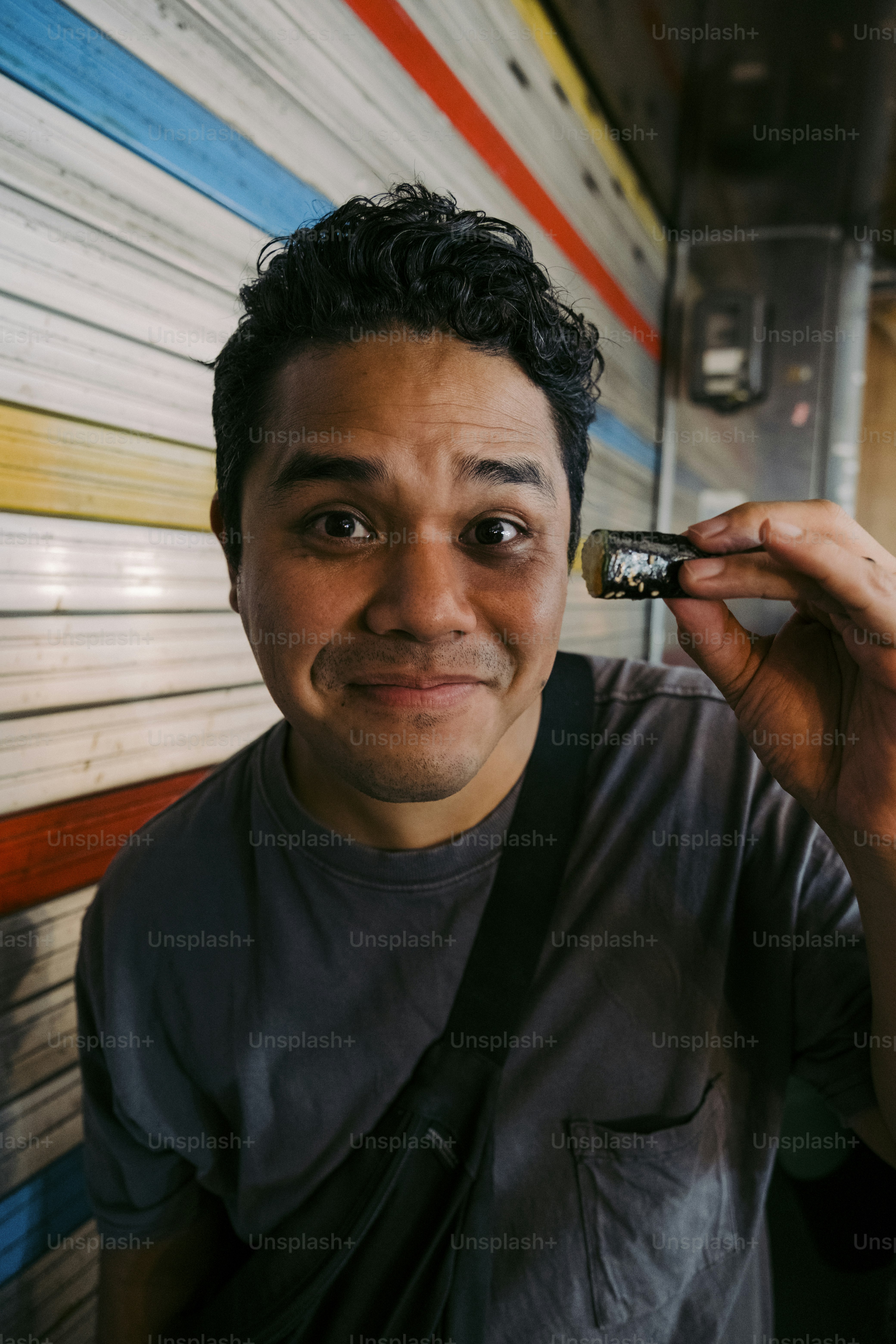 a man holding a small object up to his face