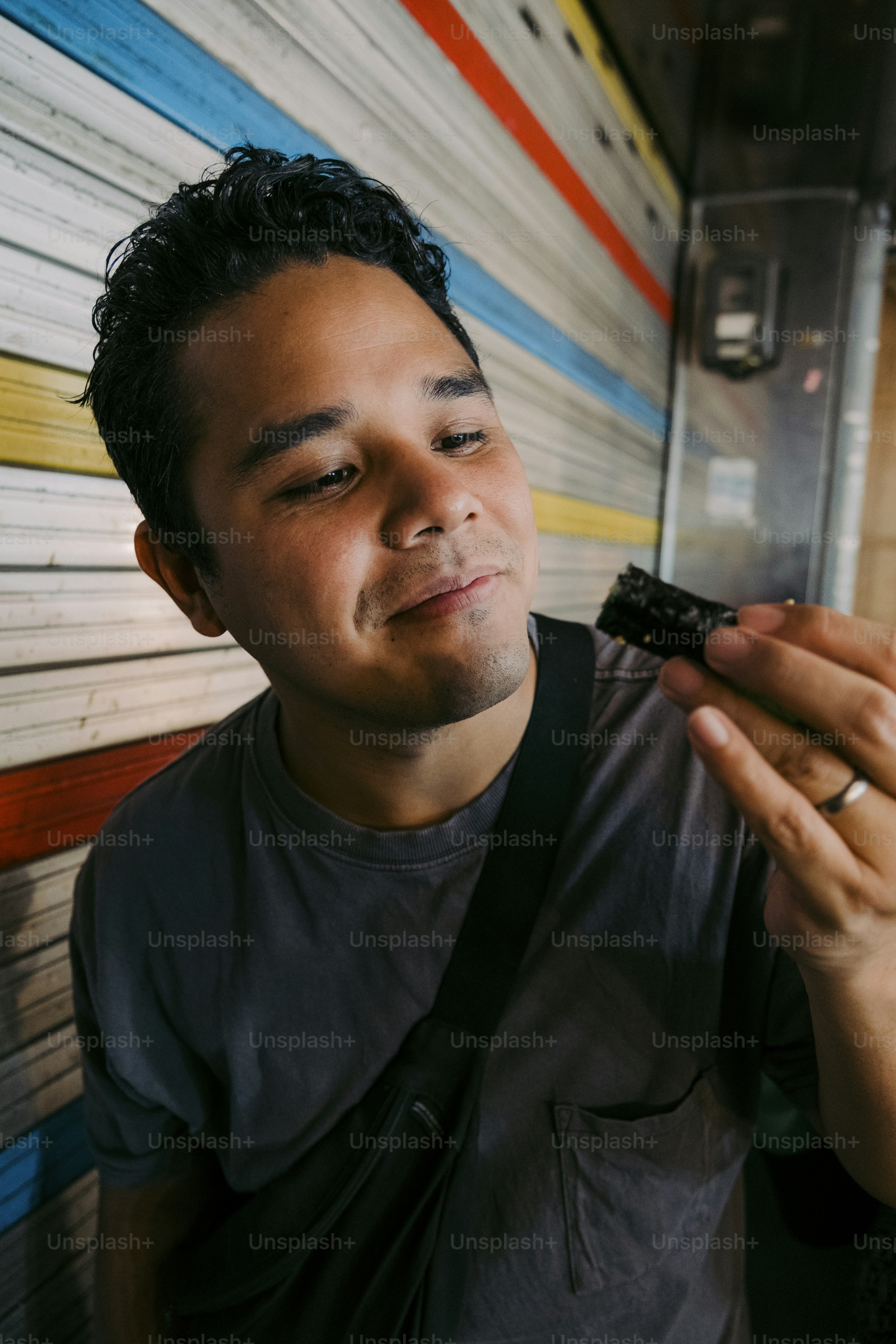 a man holding a cigarette in his right hand