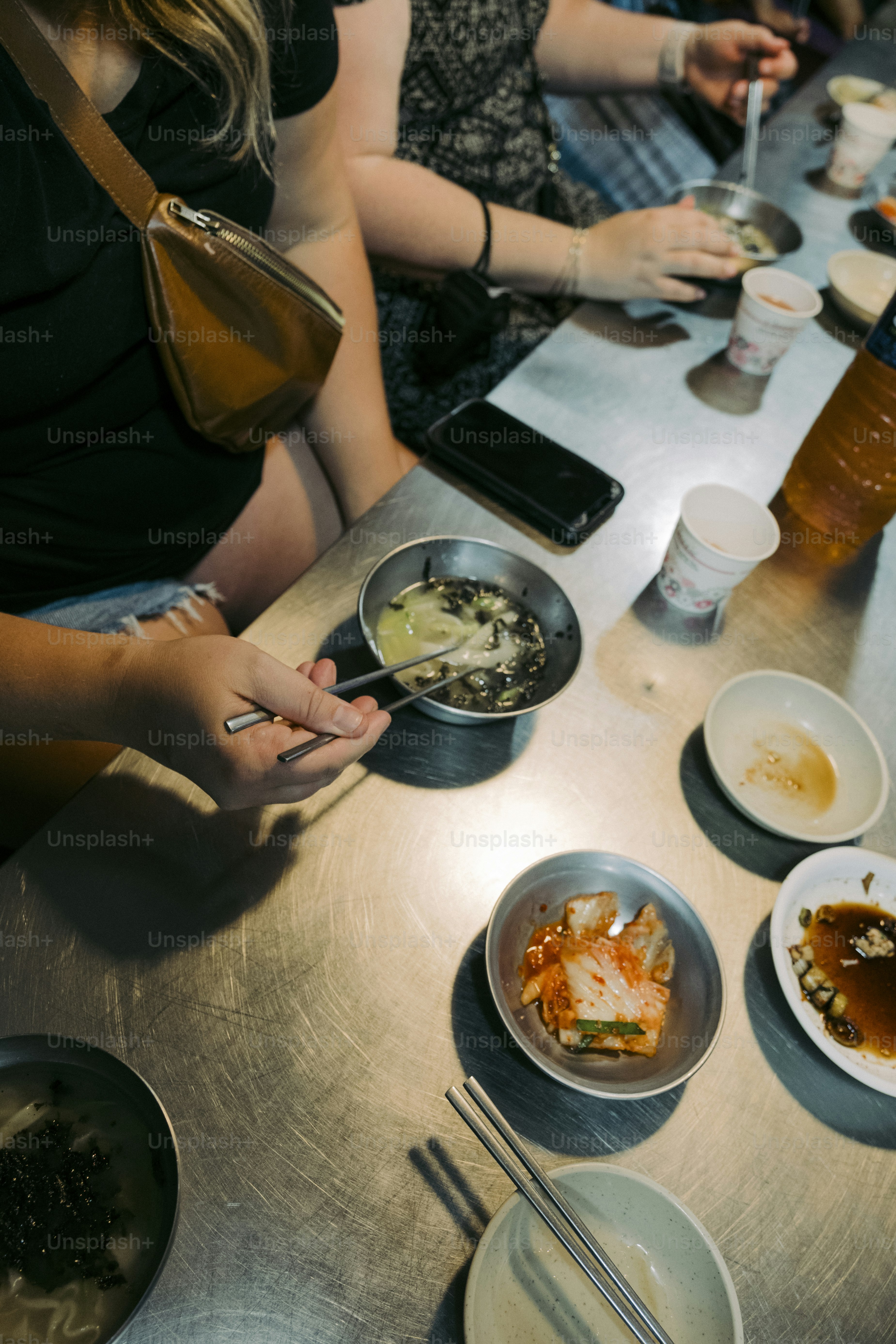 a group of people sitting around a table eating food