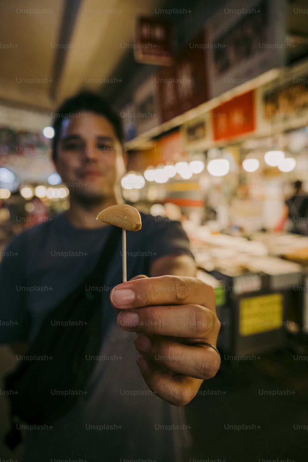 a man holding a toothpick in his hand