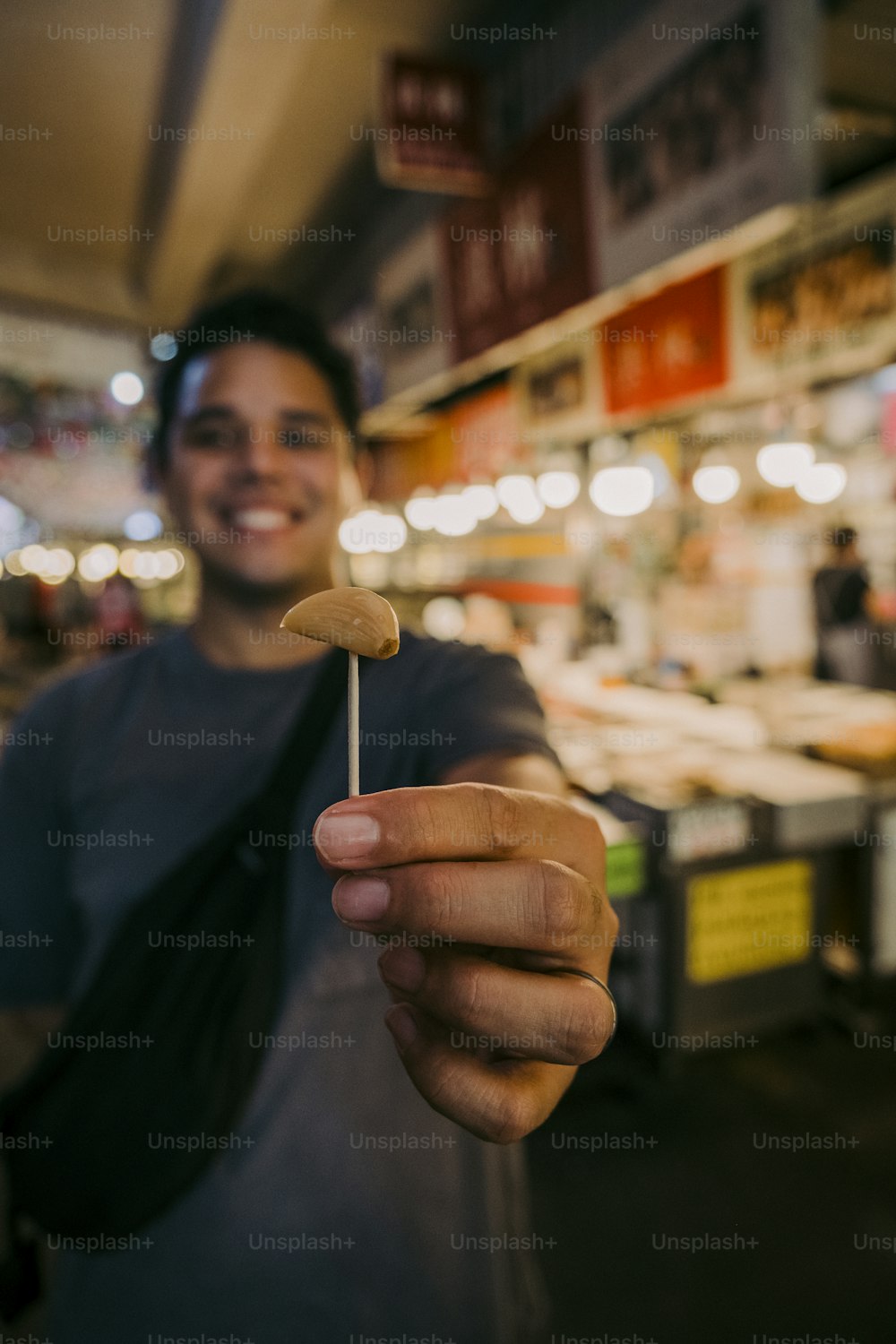a man holding a toothpick in his hand
