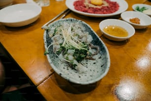 a wooden table topped with plates of food