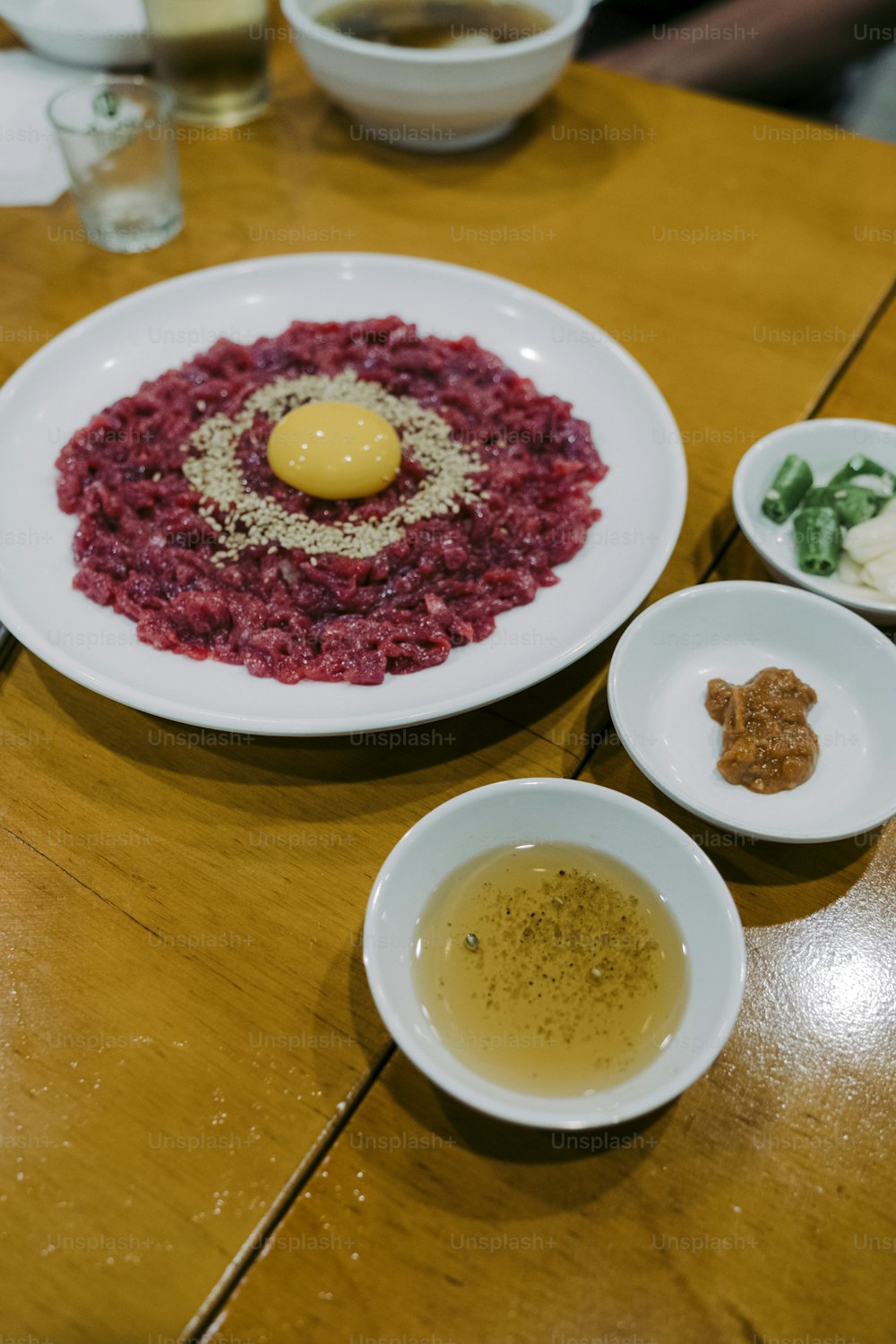 a wooden table topped with plates of food