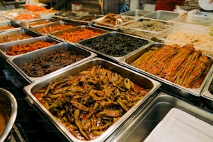 a bunch of trays of food that are on a table