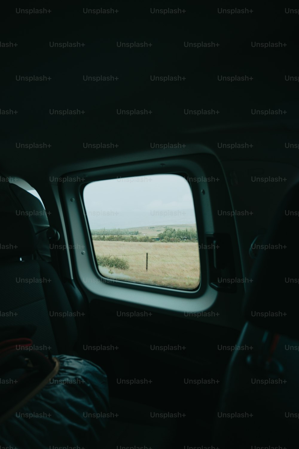 a view of a field through a window of a plane