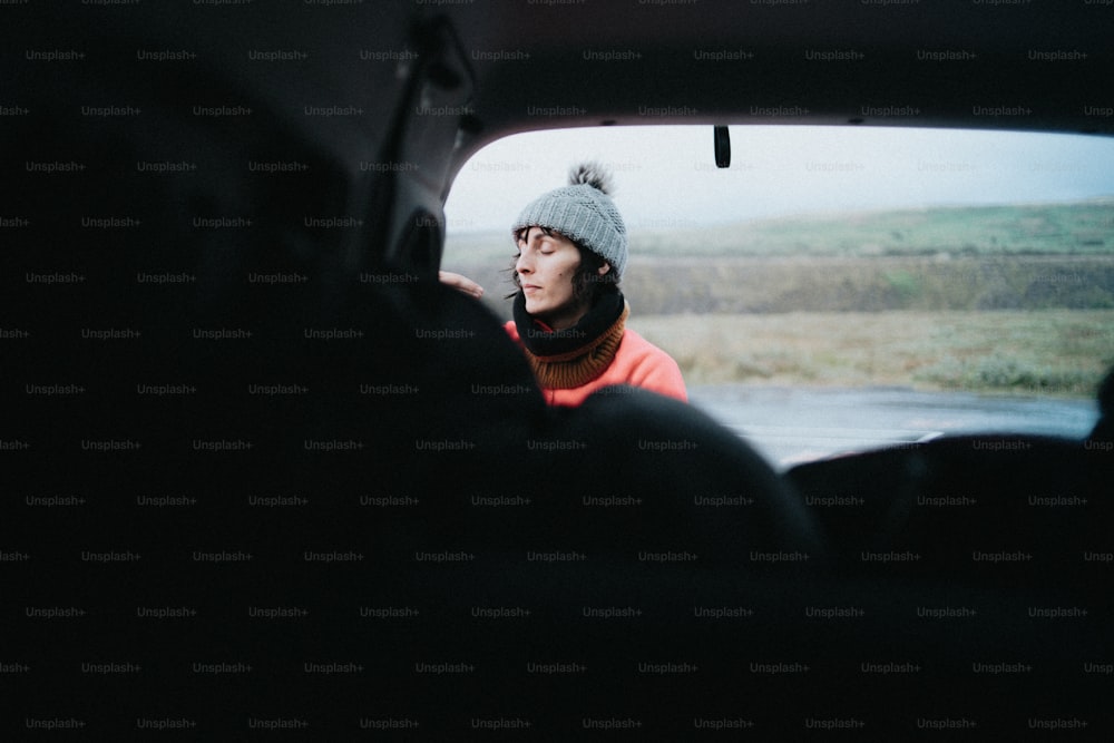a woman in a car looking out the window