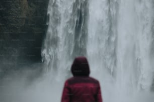 a person standing in front of a waterfall