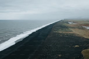 Una larga extensión de arena negra junto al océano