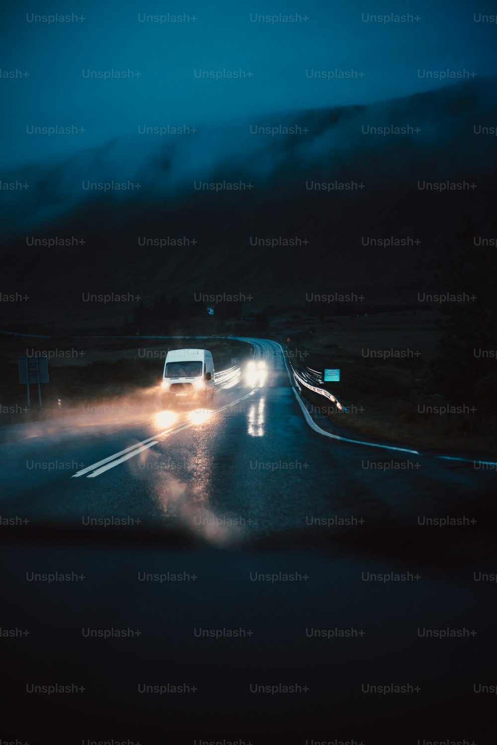 a car driving down a road at night