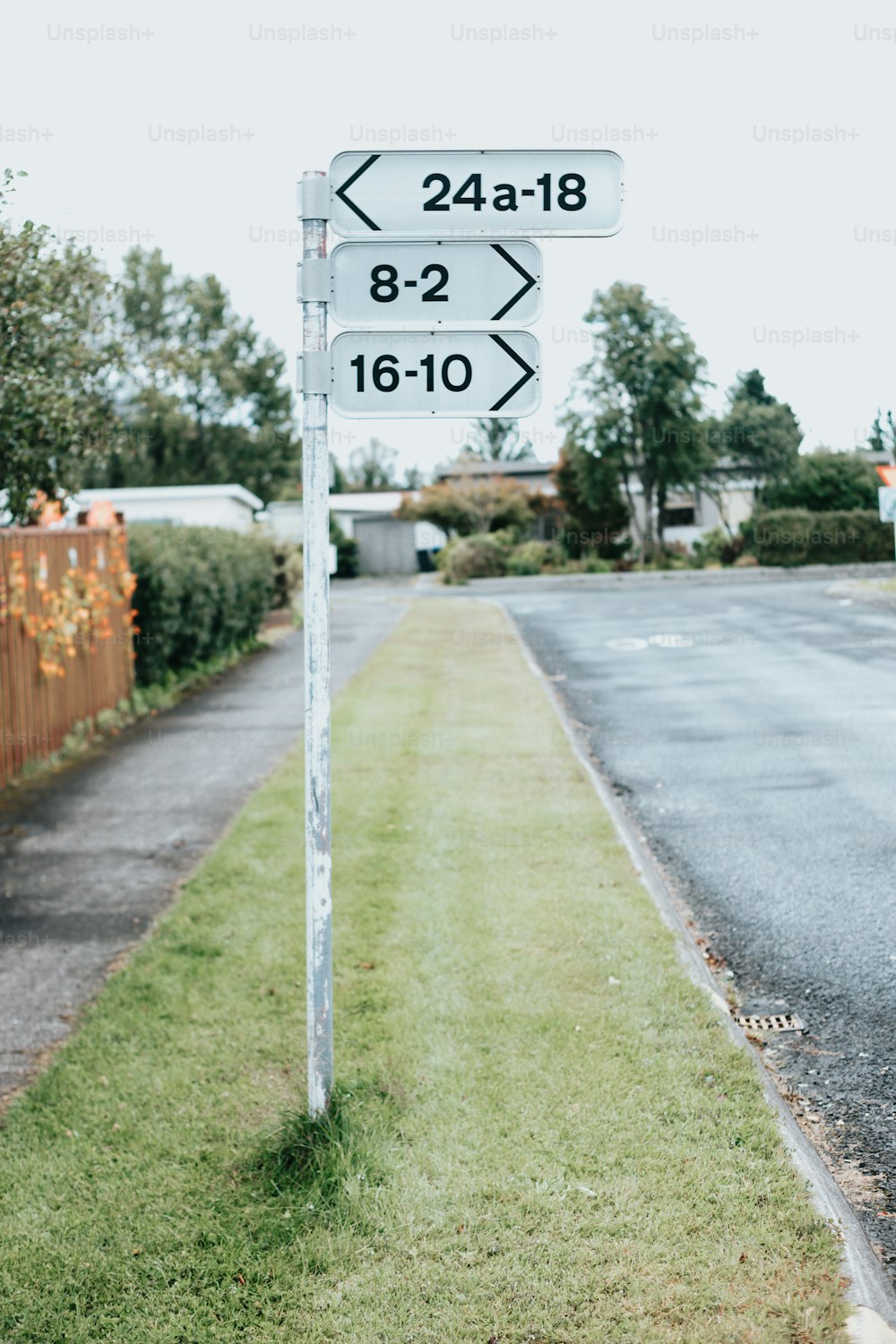 a white street sign sitting on the side of a road