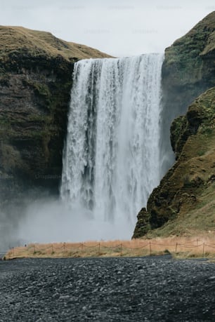 a large waterfall with a fence in front of it