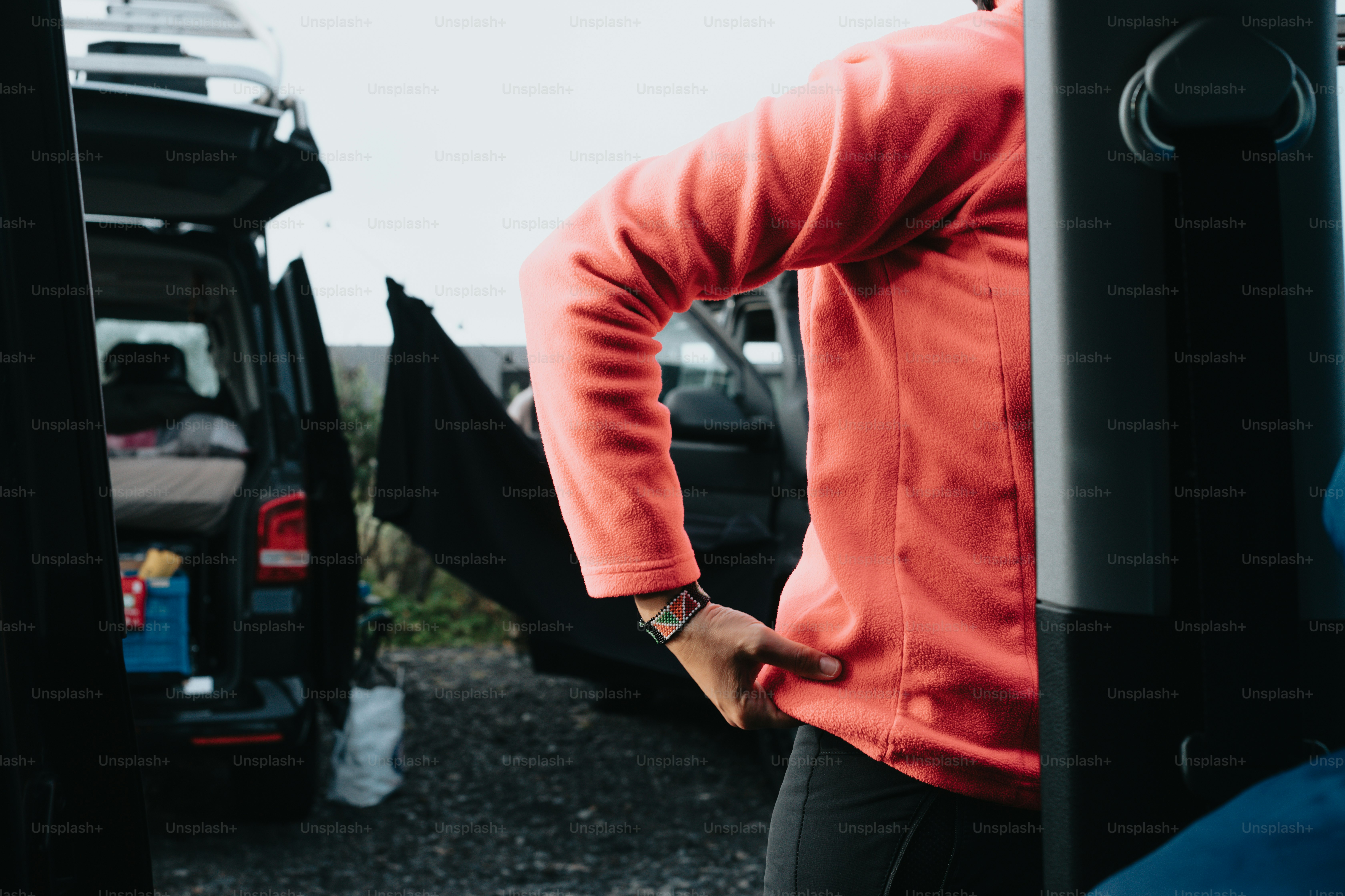a man standing next to a parked van