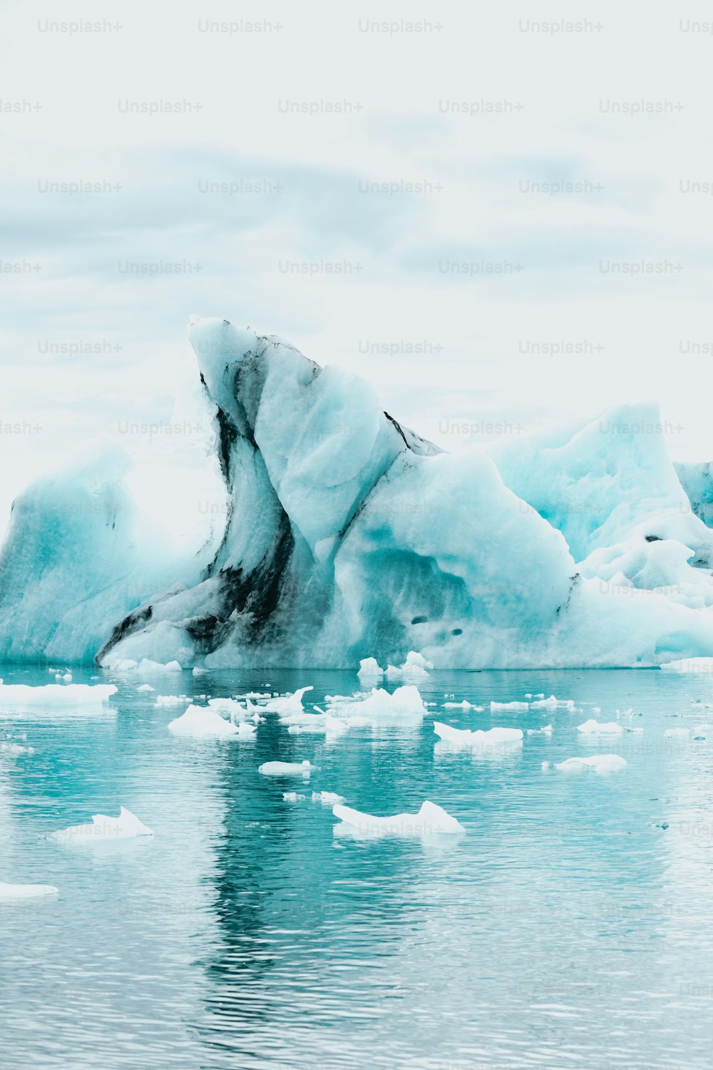 Un gros iceberg flottant au milieu d’un plan d’eau