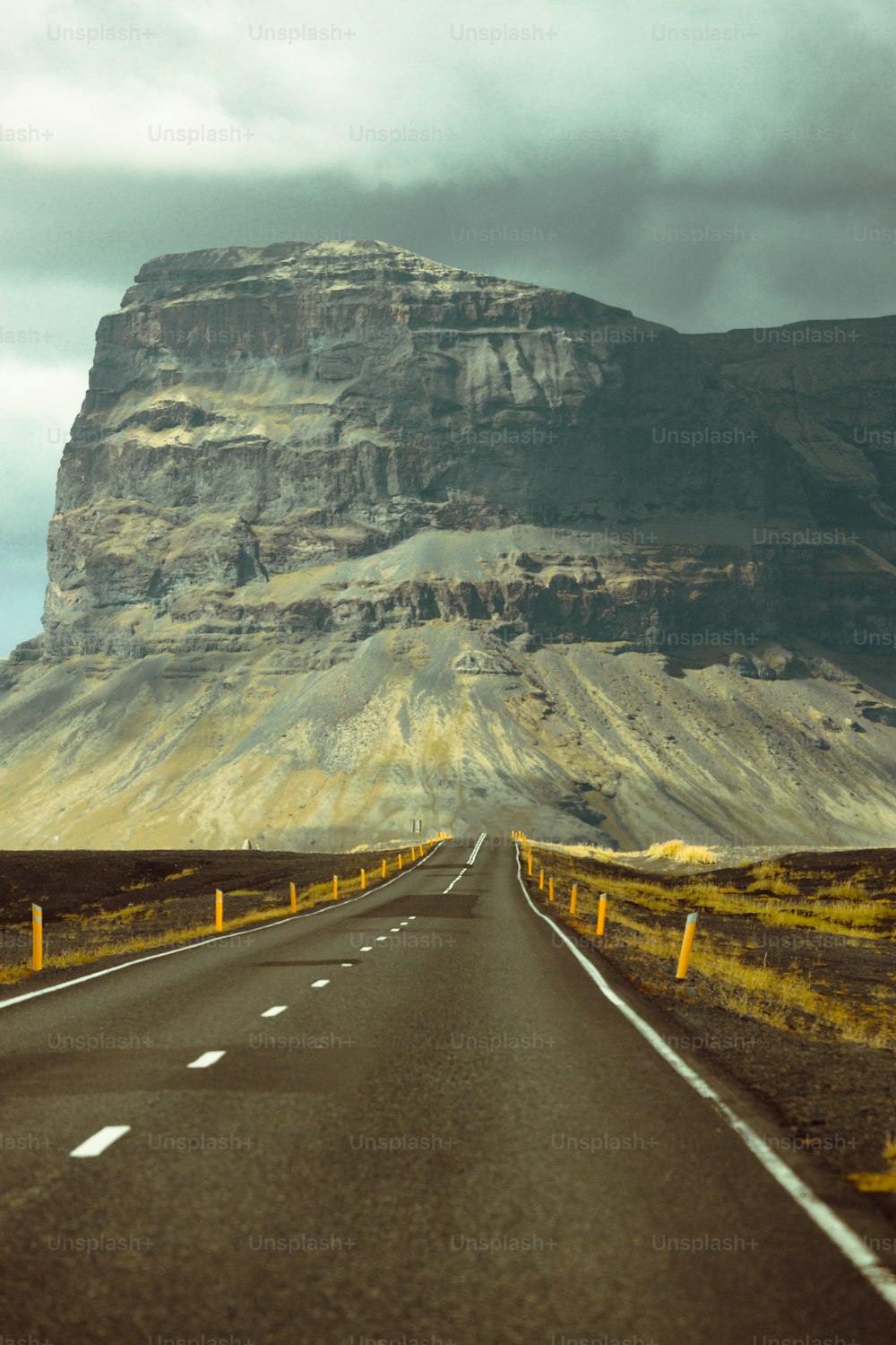 a road with a mountain in the background