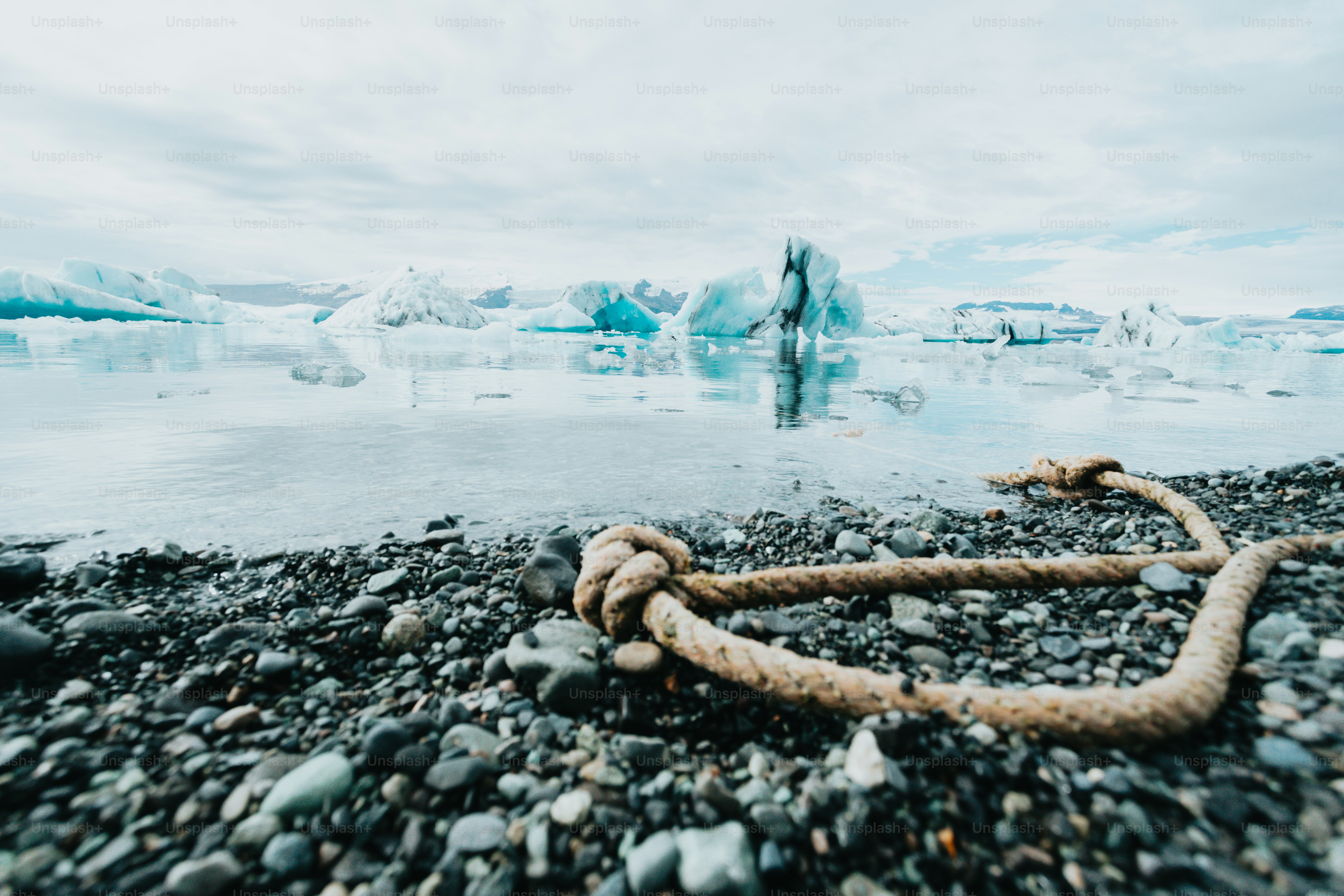 a rope laying on top of a rocky beach